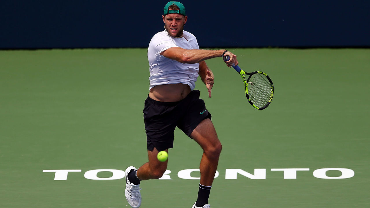 TORONTO, ON - AUGUST 06: Jack Sock of the United States plays a shot against Daniil Medvedev of Russia during a 1st round match on Day 1 of the Rogers Cup at Aviva Centre on August 6, 2018 in Toronto, Canada.