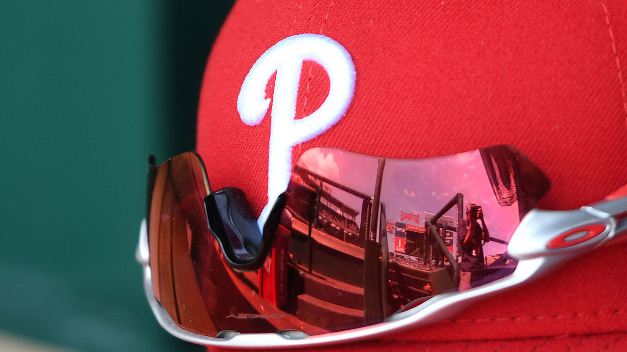 WASHINGTON, DC - APRIL 16: A Philadelphia Phillies cap and glove in the dugout before a baseball game against the Washington Nationals at Nationals Park on April 16, 2017 in Washington, D.C.