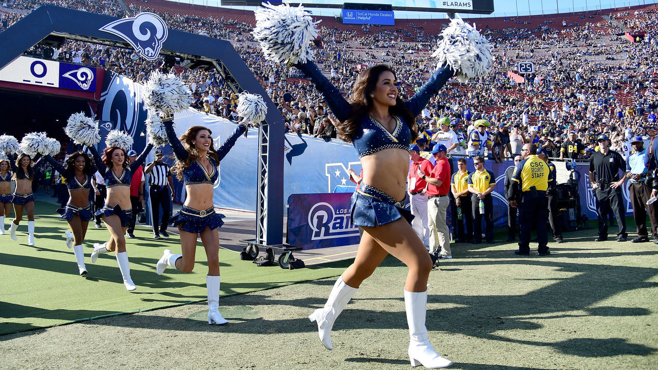 LOS ANGELES, CA - NOVEMBER 26: The Los Angeles Rams Cheerleaders run onto the field prior to the game between the Los Angeles Rams and New Orleans Saints at the Los Angeles Memorial Coliseum on November 26, 2017 in Los Angeles, California.