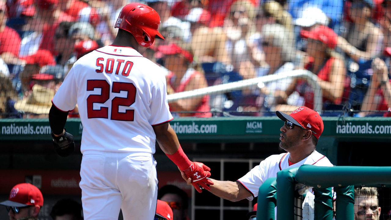 WASHINGTON, DC - AUGUST 04: Juan Soto #22 of the Washington Nationals celebrates with manager Dave Martinez #4 after scoring in the second inning against the Cincinnati Reds during game one of a doubleheader at Nationals Park on August 4, 2018 in Washington, DC.