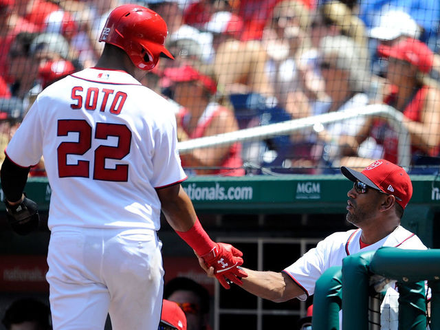 WASHINGTON, DC - AUGUST 04: Juan Soto #22 of the Washington Nationals celebrates with manager Dave Martinez #4 after scoring in the second inning against the Cincinnati Reds during game one of a doubleheader at Nationals Park on August 4, 2018 in Washington, DC.