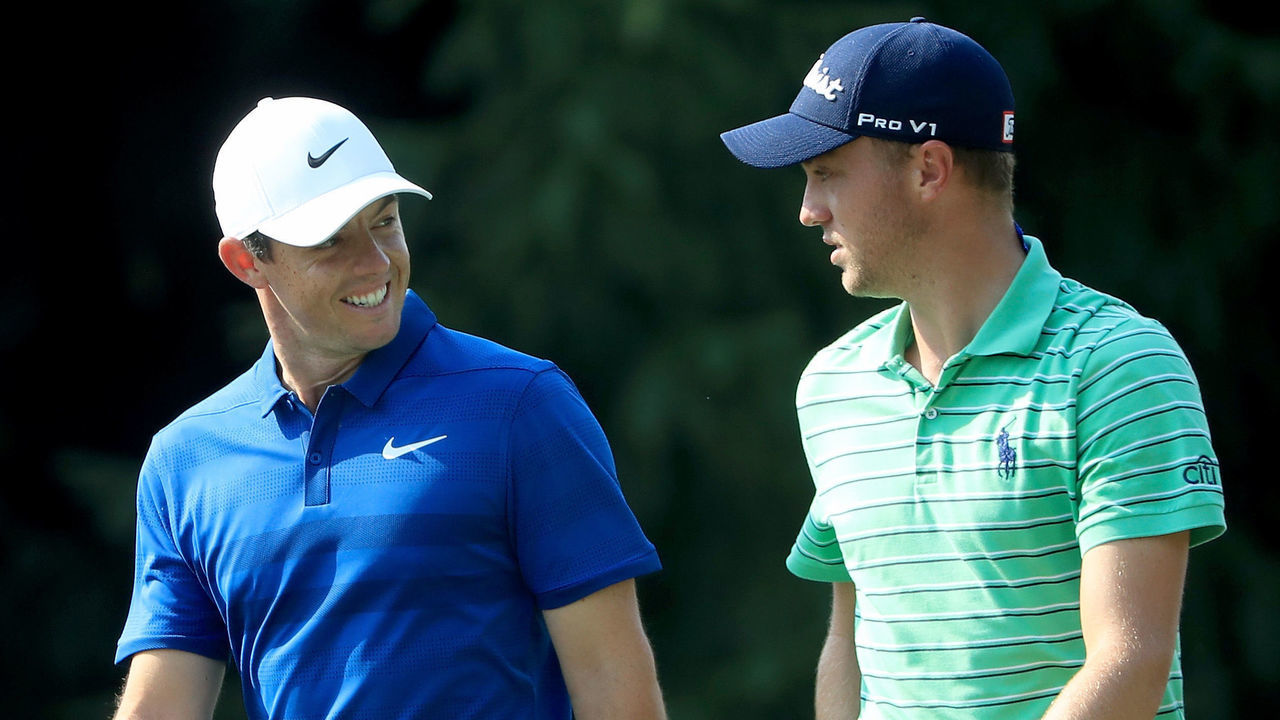 AKRON, OH - AUGUST 05: Rory McIlroy of Northern Ireland (L) and Justin Thomas meet walking across the 14th hole during the World Golf Championships-Bridgestone Invitational - Final Round at Firestone Country Club South Course on August 5, 2018 in Akron, Ohio.