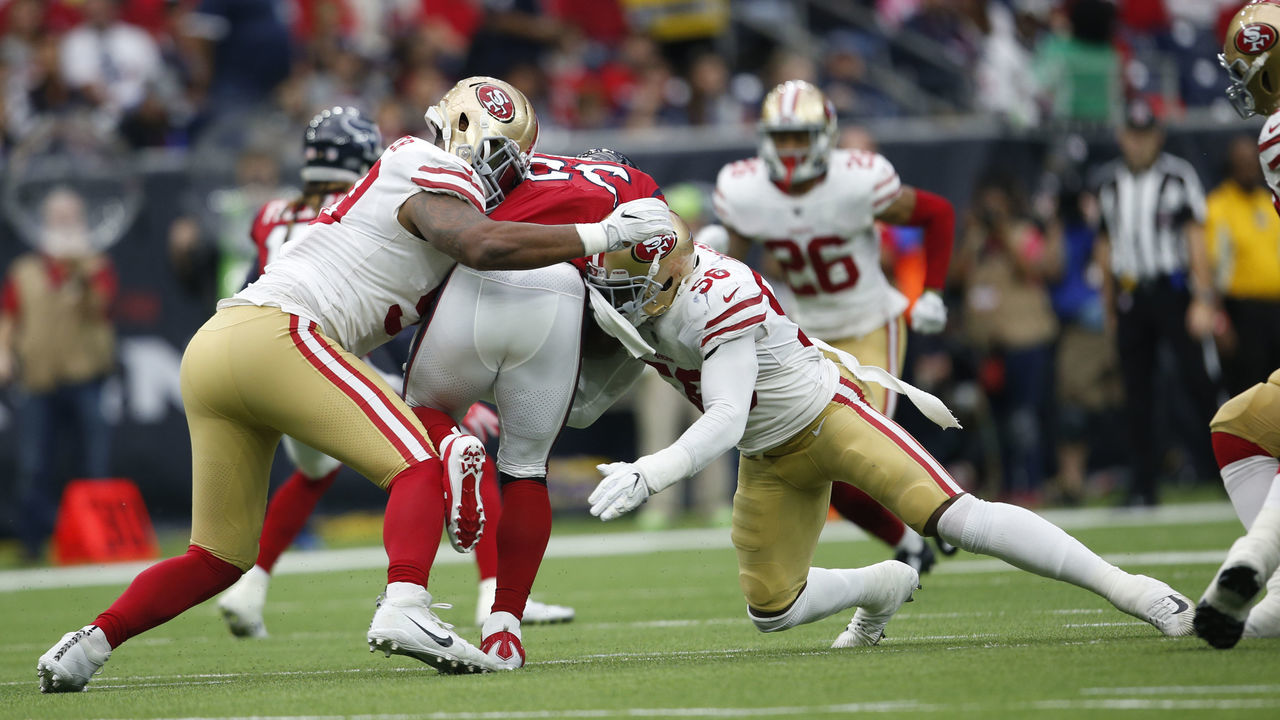 HOUSTON, TX - DECEMBER 10: Reuben Foster #56 and DeForest Buckner #99 of the San Francisco 49ers tackle Lamar Miller #26 of the Houston Texans during the game at NRG Stadium on December 10, 2017 in Houston, Texas. The 49ers defeated the Texans 26-16.