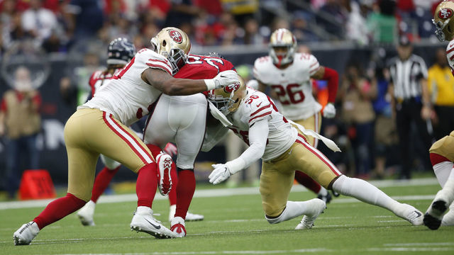 HOUSTON, TX - DECEMBER 10: Reuben Foster #56 and DeForest Buckner #99 of the San Francisco 49ers tackle Lamar Miller #26 of the Houston Texans during the game at NRG Stadium on December 10, 2017 in Houston, Texas. The 49ers defeated the Texans 26-16.