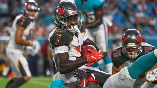 MIAMI, FL - AUGUST 09: Ronald Jones #27 of the Tampa Bay Buccaneers scores a touchdown in the second quarter during a preseason game against the Miami Dolphins at Hard Rock Stadium on August 9, 2018 in Miami, Florida.