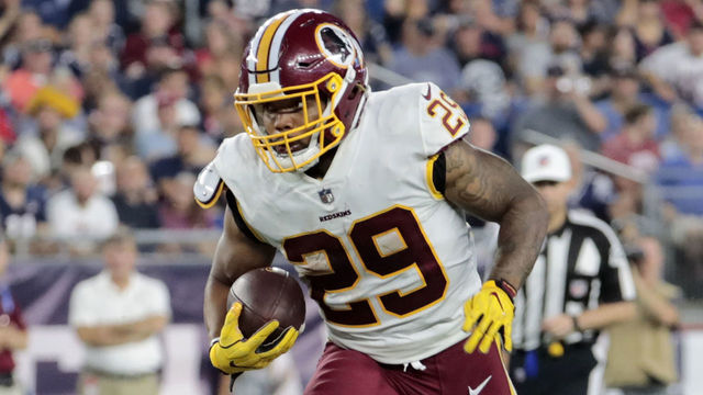 FOXBOROUGH, MA - AUGUST 09: Washington Redskins running back Derrius Guice (29) breaks through the line during a preseason NFL game between the New England Patriots and the Washington Redskins on August 9, 2018, at Gillette Stadium in Foxborough, Massachusetts. The Patriots defeated the Redskins 26-17.