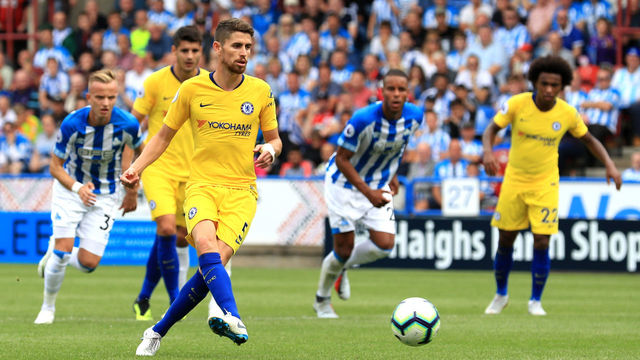 HUDDERSFIELD, ENGLAND - AUGUST 11: Jorginho of Chelsea scores a penalty for his team's second goal during the Premier League match between Huddersfield Town and Chelsea FC at John Smith's Stadium on August 11, 2018 in Huddersfield, United Kingdom.
