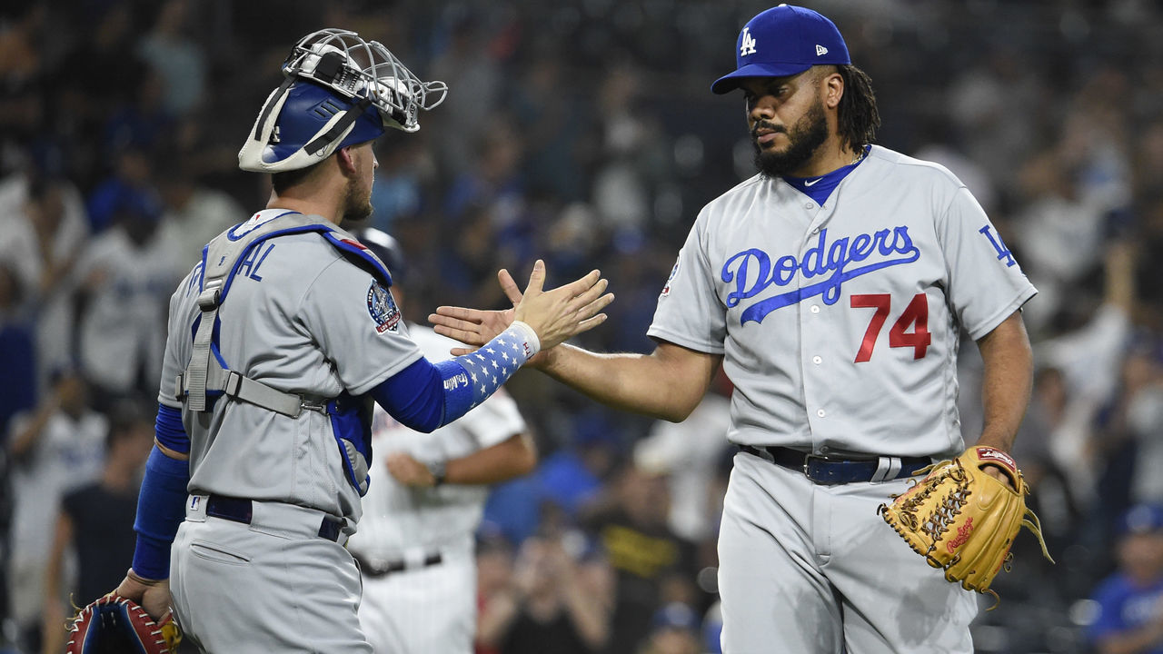 SAN DIEGO, CA - JULY 11: Kenley Jansen #74 of the Los Angeles Dodgers is congratulated by Yasmani Grandal #9 after beating the San Diego Padres 4-2 in a baseball game at PETCO Park on July 11, 2018 in San Diego, California.