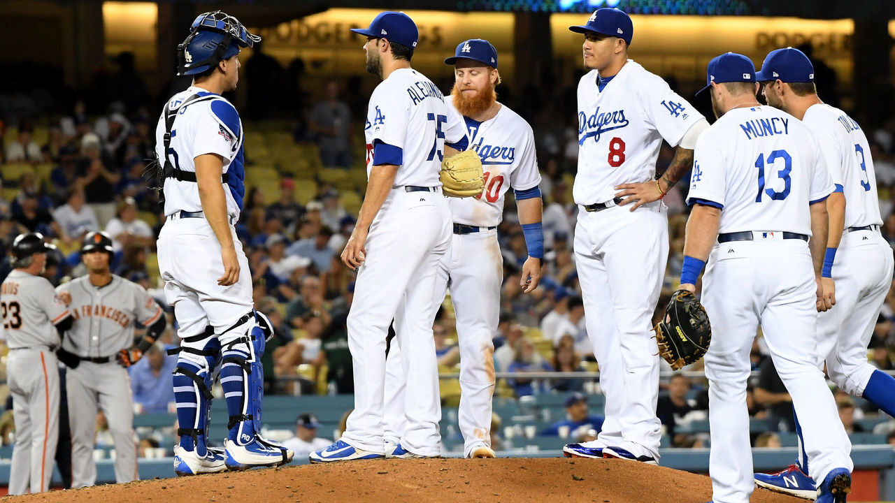 LOS ANGELES, CA - AUGUST 13: Scott Alexander #75 of the Los Angeles Dodgers reacts in front of Justin Turner #10 and Manny Machado #8, as he leaves the game after allowing four runs to the San Francisco Giants to trail 5-2 during the ninth inning at Dodger Stadium on August 13, 2018 in Los Angeles, California.
