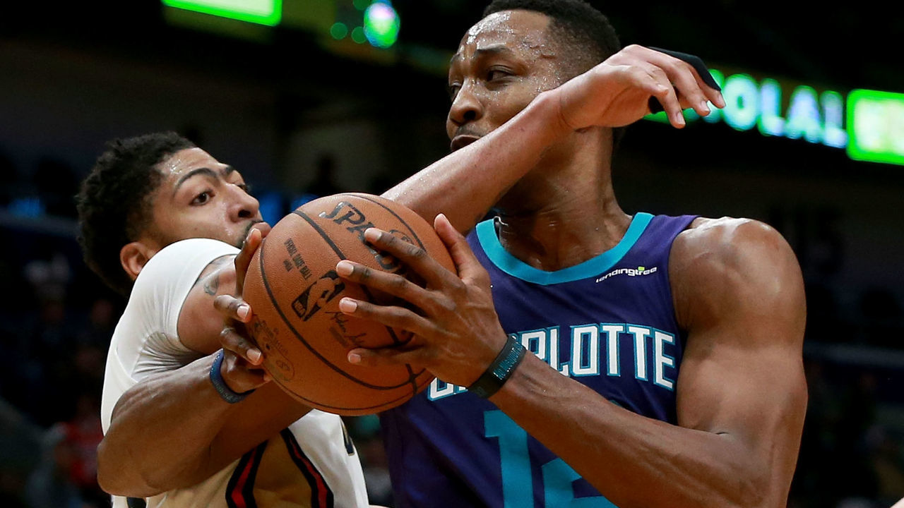NEW ORLEANS, LA - MARCH 13: Dwight Howard #12 of the Charlotte Hornets is fluled by Anthony Davis #23 of the New Orleans Pelicans during the second half of a NBA game at the Smoothie King Center on March 13, 2018 in New Orleans, Louisiana.