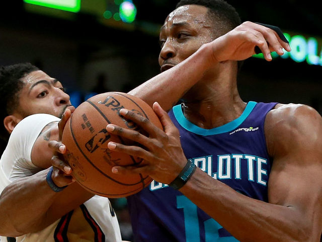 NEW ORLEANS, LA - MARCH 13: Dwight Howard #12 of the Charlotte Hornets is fluled by Anthony Davis #23 of the New Orleans Pelicans during the second half of a NBA game at the Smoothie King Center on March 13, 2018 in New Orleans, Louisiana.