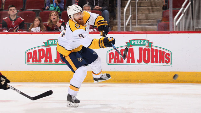 GLENDALE, AZ - JANUARY 04: Ryan Ellis #4 of the Nashville Predators shoots the puck ahead of Jakob Chychrun #6 of the Arizona Coyotes during the first period of the NHL game at Gila River Arena on January 4, 2018 in Glendale, Arizona.