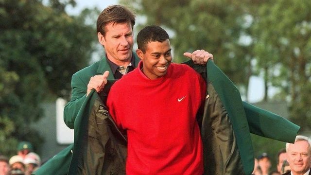 AUGUSTA, : Tiger Woods (R) receives the Masters green jacket for winning the 1997 Masters Tournament 13 April from 1996 winner Nick Faldo at Augusta National Golf Club in Georgia. Woods won the tournament with a record eighteen-under-par. (ELECTRONIC IMAGE) AFP PHOTO/Jeff HAYNES