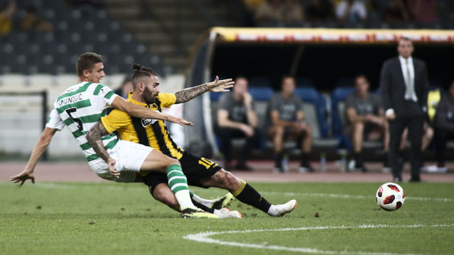 ATHENS, GREECE - AUGUST 14: Jozo Simunovic (D) of Celtic and Marko Livaja, (F) of AEK Athens battle for the ball during the UEFA Champions League, Qualifying Third Round 2nd Leg match between AEK Athens and Celtic, at OAKA stadium, on August 14, 2018 in Athens, Greece.