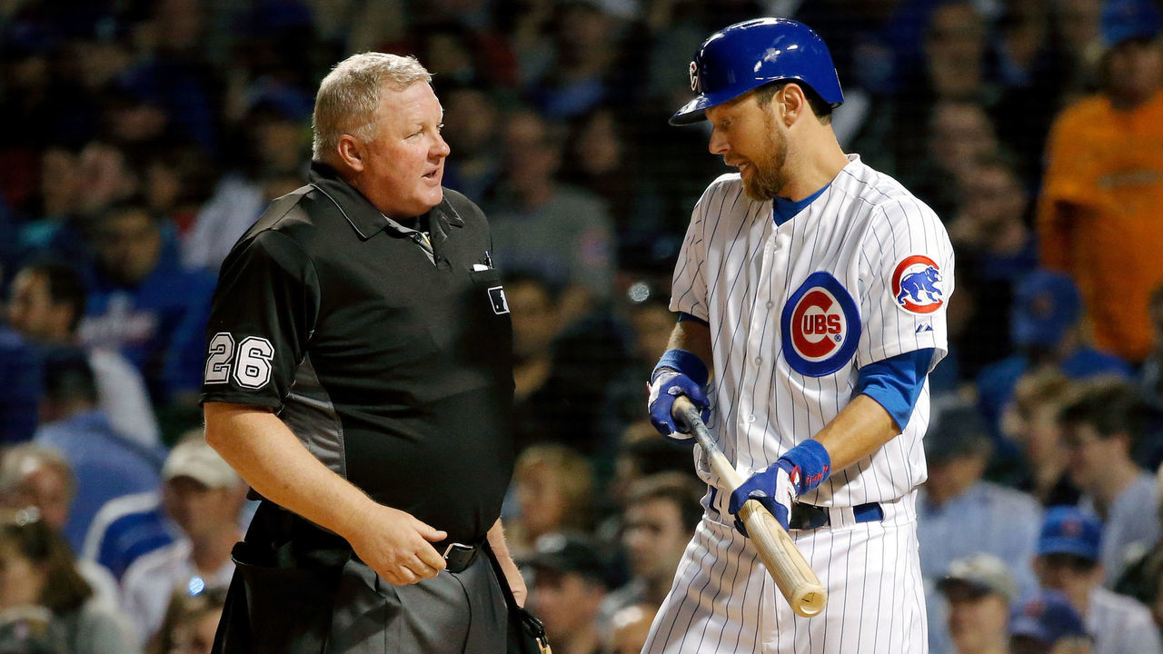 CHICAGO, IL - APRIL 18: Ben Zobrist #18 of the Chicago Cubs talks with home plate umpire Bill Miller #26 after striking out to end the third inning at Wrigley Field on April 18, 2017 in Chicago, Illinois.