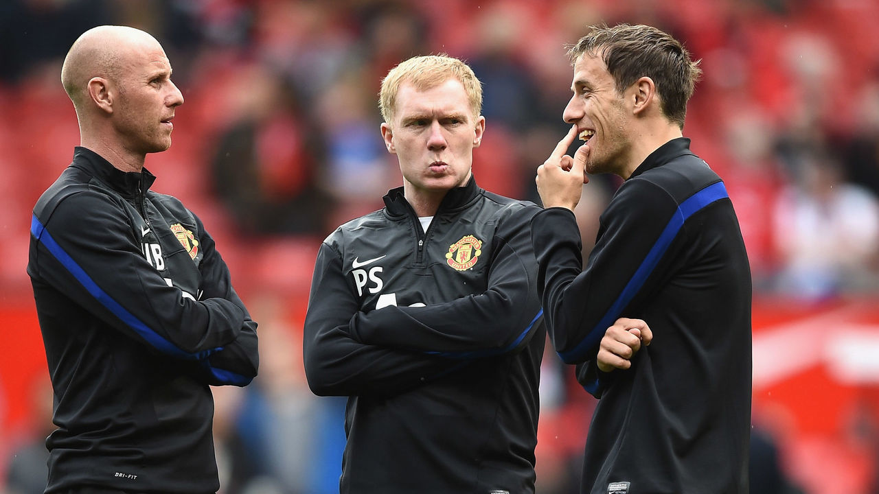 MANCHESTER, ENGLAND - APRIL 26: l-r Nicky Butt, Paul Scholes and Phil Neville of Manchester United watch over the players during warm up during the Barclays Premier League match between Manchester United and Norwich City at Old Trafford on April 26, 2014 in Manchester, England.