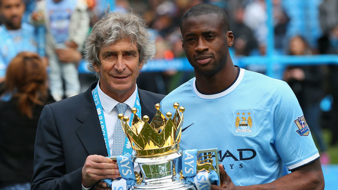 MANCHESTER, ENGLAND - MAY 11: The Manchester City Manager Manuel Pellegrini and Yaya Toure pose with the trophy at the end of the Barclays Premier League match between Manchester City and West Ham United at the Etihad Stadium on May 11, 2014 in Manchester, England.