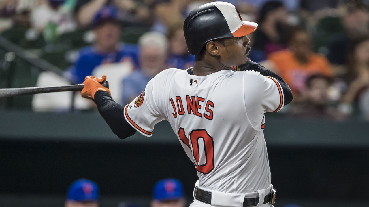 BALTIMORE, MD - AUGUST 14: Adam Jones #10 of the Baltimore Orioles hits a home run against the New York Mets during the sixth inning at Oriole Park at Camden Yards on August 14, 2018 in Baltimore, Maryland.
