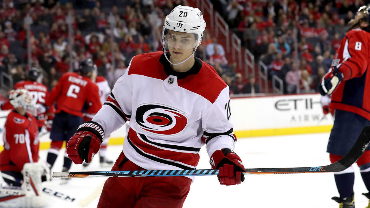 WASHINGTON, DC - MARCH 30: Sebastian Aho #20 of the Carolina Hurricanes celebrates in front of Alex Ovechkin #8 of the Washington Capitals after scoring a third period goal at Capital One Arena on March 30, 2018 in Washington, DC.