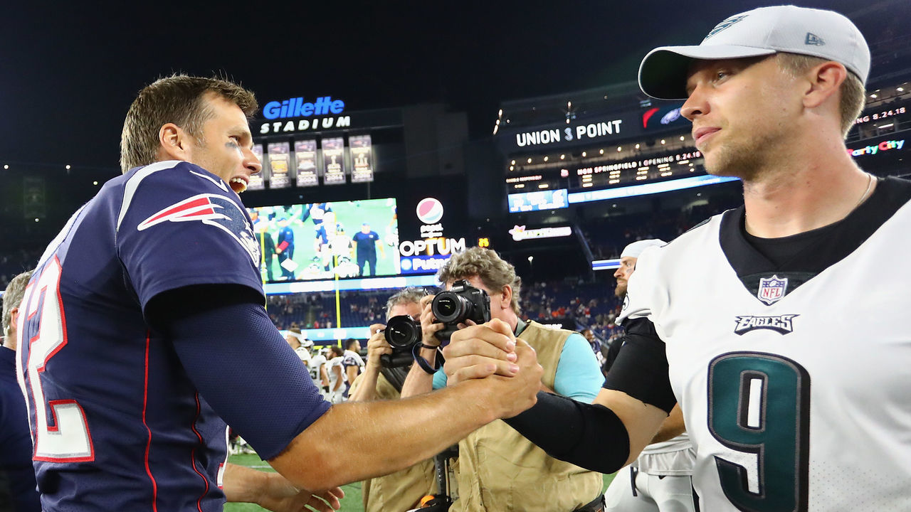 FOXBOROUGH, MA - AUGUST 16: Tom Brady #12 of the New England Patriots shakes hands with Nick Foles #9 of the Philadelphia Eagles after the Patriots defeated the Eagles 37-20 in a preseason game at Gillette Stadium on August 16, 2018 in Foxborough, Massachusetts.