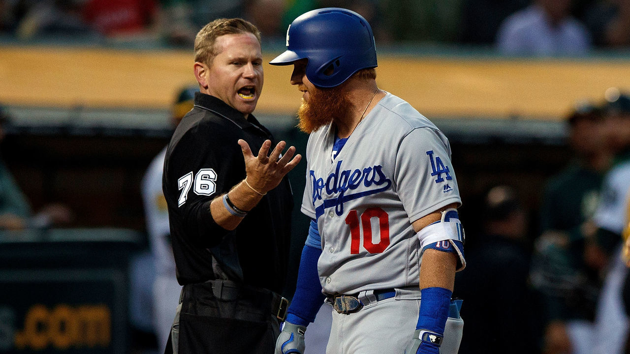 OAKLAND, CA - AUGUST 08: Justin Turner #10 of the Los Angeles Dodgers argues a called third strike with umpire Mike Muchlinski #76 during the fourth inning against the Oakland Athletics at the Oakland Coliseum on August 8, 2018 in Oakland, California.