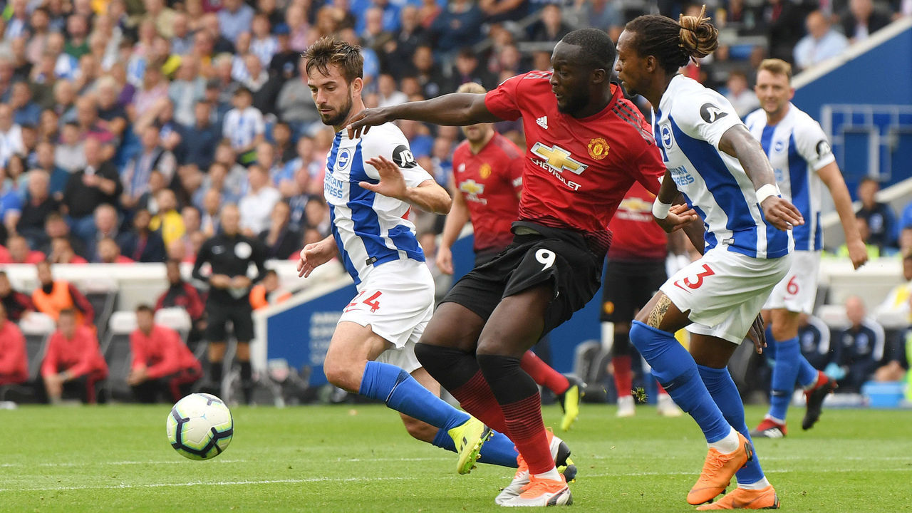 BRIGHTON, ENGLAND - AUGUST 19: Romelu Lukaku of Manchester United is challenged by Gaetan Bong of Brighton and Hove Albion during the Premier League match between Brighton & Hove Albion and Manchester United at American Express Community Stadium on August 19, 2018 in Brighton, United Kingdom.