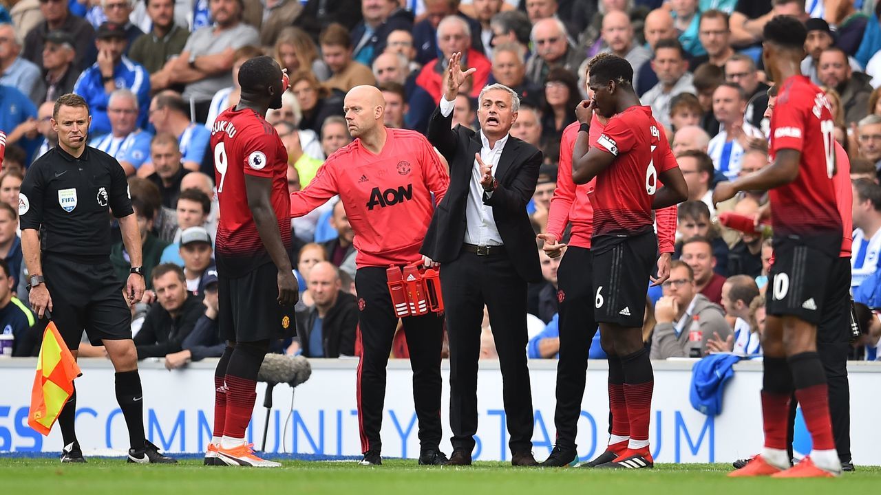 Manchester United's Portuguese manager Jose Mourinho (C) gestures as he talks with his players Manchester United's Belgian striker Romelu Lukaku (L) and Manchester United's French midfielder Paul Pogba (R) during the English Premier League football match between Brighton and Hove Albion and Manchester United at the American Express Community Stadium in Brighton, southern England on August 19, 2018.