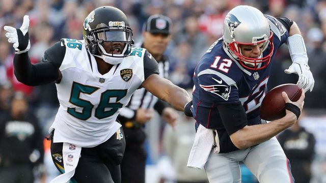 FOXBOROUGH, MA - JANUARY 21: Tom Brady #12 of the New England Patriots is pursued by Dante Fowler Jr. #56 of the Jacksonville Jaguars in the first quarter during the AFC Championship Game at Gillette Stadium on January 21, 2018 in Foxborough, Massachusetts.