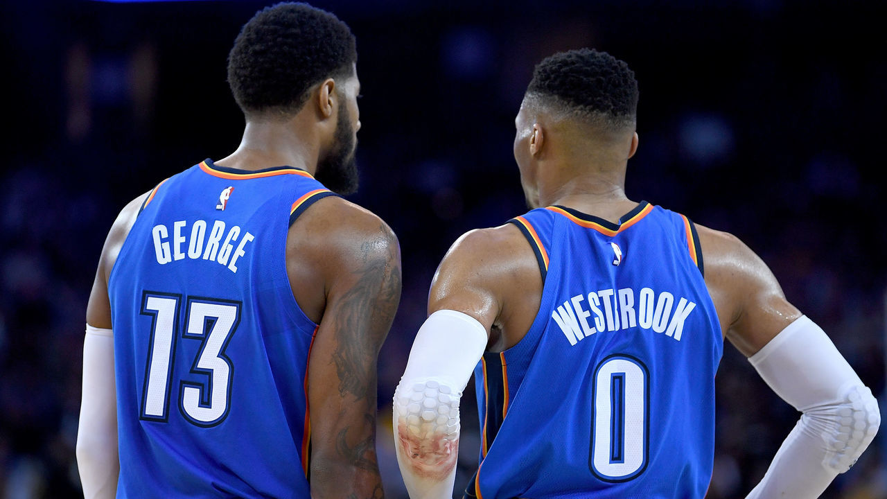 OAKLAND, CA - FEBRUARY 06: Paul George #13 and Russell Westbrook #0 of the Oklahoma City Thunder looks on against the Golden State Warriors during the second half of their NBA basketball game at ORACLE Arena on February 6, 2018 in Oakland, California.