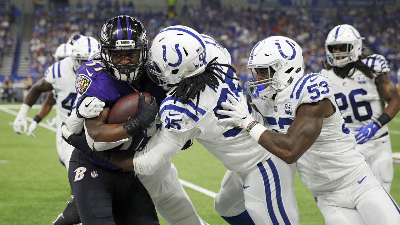 INDIANAPOLIS, IN - AUGUST 20: Denico Autry #95 and Darius Leonard #53 of the Indianapolis Colts tackle Javorius Allen #37 of the Baltimore Ravens in the second quarter of a preseason game at Lucas Oil Stadium on August 20, 2018 in Indianapolis, Indiana.