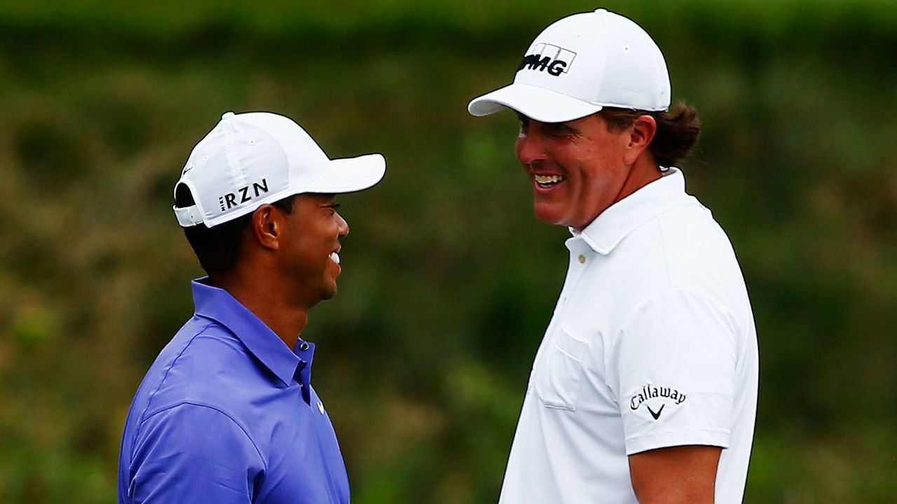 LOUISVILLE, KY - AUGUST 07: (L-R) Tiger Woods of the United States and Phil Mickelson of the United States laugh together on the 16th green during the first round of the 96th PGA Championship at Valhalla Golf Club on August 7, 2014 in Louisville, Kentucky.