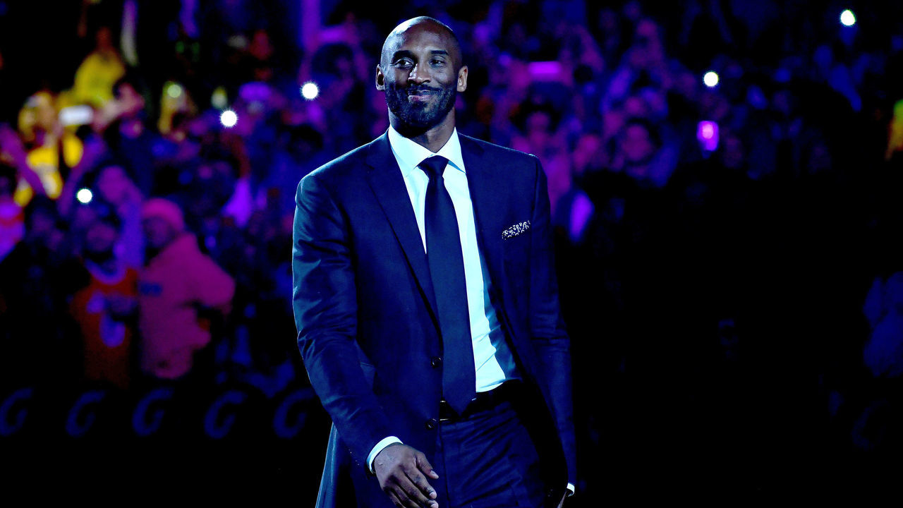 LOS ANGELES, CA - DECEMBER 18: Kobe Bryant smiles at halftime as both his #8 and #24 Los Angeles Lakers jerseys are retired at Staples Center on December 18, 2017 in Los Angeles, California.