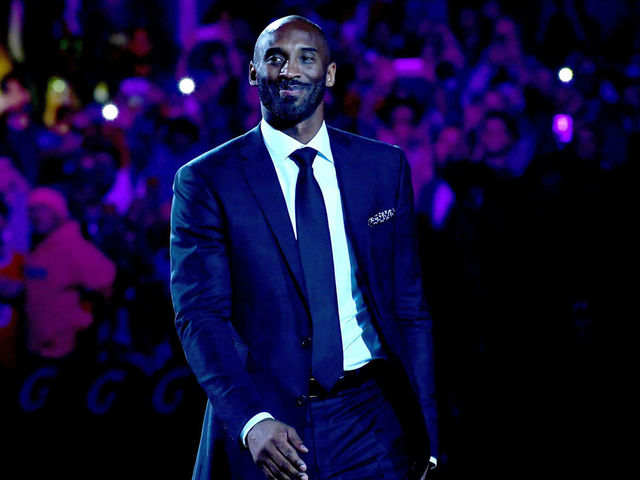LOS ANGELES, CA - DECEMBER 18: Kobe Bryant smiles at halftime as both his #8 and #24 Los Angeles Lakers jerseys are retired at Staples Center on December 18, 2017 in Los Angeles, California.