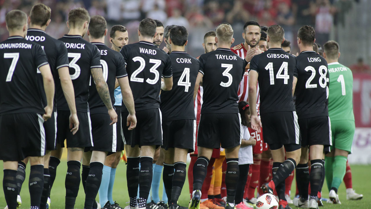 PIRAEUS, GREECE - AUGUST 23: The players of Burnley FC shake hands with the players of Olympiacos FC during the grid of Europa League - Qualifying Play-Offs - 1st Leg match between Olympiacos FC and Burnley FC at Karaiskakis Stadium on August 23, 2018 in Piraeus, Greece.