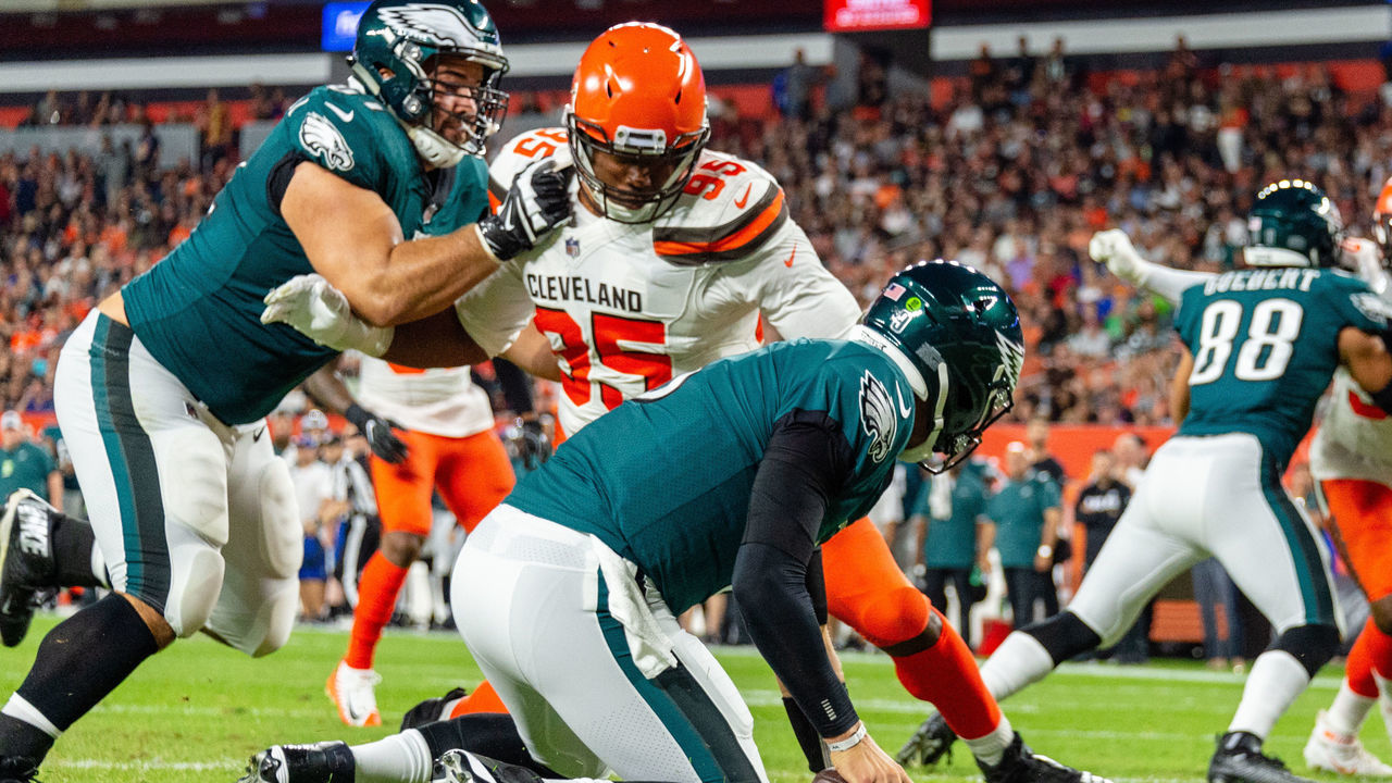 CLEVELAND, OH - AUGUST 23: Starting quarterback Nick Foles #9 of the Philadelphia Eagles trips and falls to the ground for a safety while under pressure from Myles Garrett #95 of the Cleveland Browns and protection from Stefen Wisniewski #61 during the first half of a preseason game at FirstEnergy Stadium on August 23, 2018 in Cleveland, Ohio.