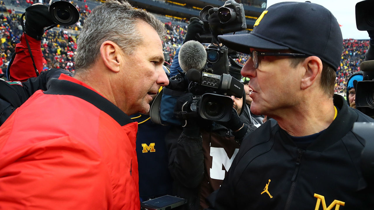 ANN ARBOR, MI - NOVEMBER 25: Urban Meyer head coach of the Ohio State Buckeyes and Jim Harbaugh head coach of the Michigan Wolverines shake hands after the game. Ohio State won 31 to 20 on November 25, 2017 at Michigan Stadium in Ann Arbor, Michigan.