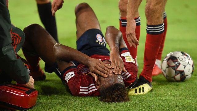 Bayern Munich's French forward Kingsley Coman receives medical attention during the German first division Bundesliga football match FC Bayern Munich v TSG 1899 Hoffenheim at the Allianz Arena in Munich, southern Germany on August 24, 2018.