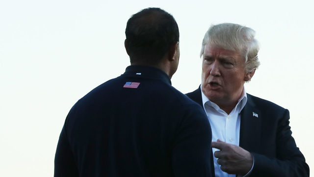 JERSEY CITY, NJ - OCTOBER 01: U.S. President Donald Trump talks to Captain's assistant Tiger Woods of the U.S. Team after Sunday singles matches of the Presidents Cup at Liberty National Golf Club on October 1, 2017 in Jersey City, New Jersey.