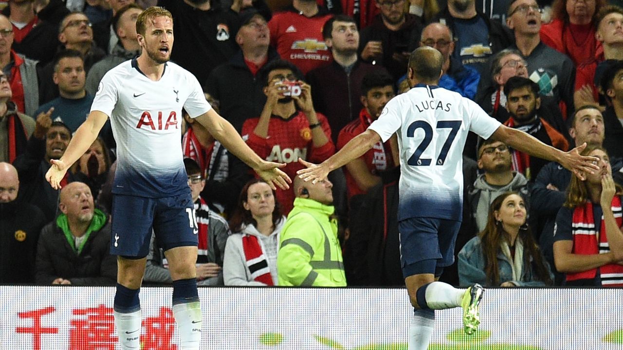 Tottenham Hotspur's English striker Harry Kane (L) celebrates scoring the opening goal with Tottenham Hotspur's Brazilian midfielder Lucas Moura (R) during the English Premier League football match between Manchester United and Tottenham Hotspur at Old Trafford in Manchester, north west England, on August 27, 2018.