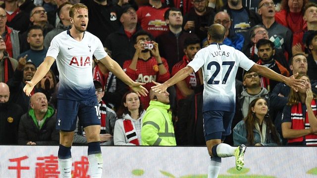 Tottenham Hotspur's English striker Harry Kane (L) celebrates scoring the opening goal with Tottenham Hotspur's Brazilian midfielder Lucas Moura (R) during the English Premier League football match between Manchester United and Tottenham Hotspur at Old Trafford in Manchester, north west England, on August 27, 2018.
