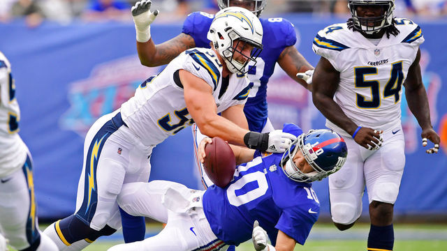EAST RUTHERFORD, NJ - OCTOBER 08: Eli Manning #10 of the New York Giants is sacked by Joey Bosa #99 of the Los Angeles Chargers during the first quarter during an NFL game at MetLife Stadium on October 8, 2017 in East Rutherford, New Jersey.