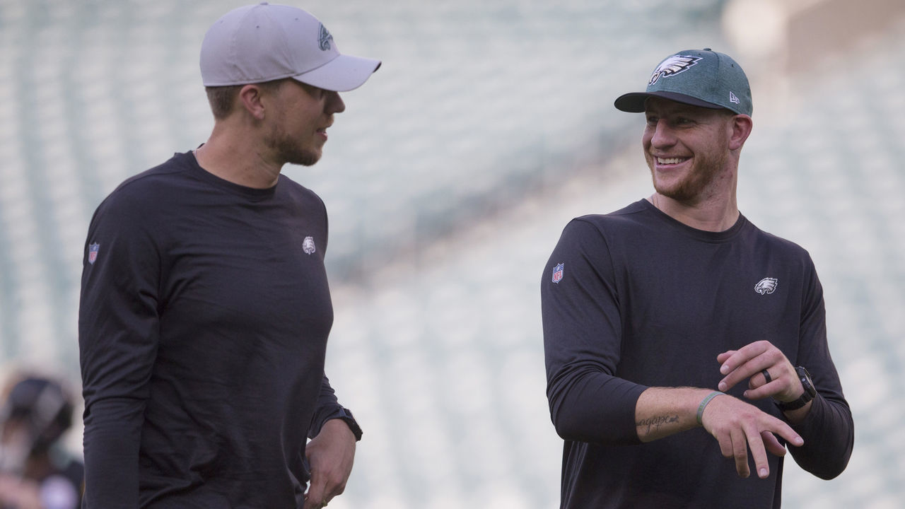 PHILADELPHIA, PA - AUGUST 09: Nick Foles #9 of the Philadelphia Eagles talks to Carson Wentz #11 prior to the preseason game at Lincoln Financial Field on August 9, 2018 in Philadelphia, Pennsylvania.