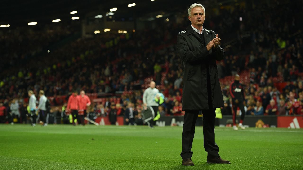 Manchester United's Portuguese manager Jose Mourinho stands on the pitch applauding the homes fans that stayed until the end after the English Premier League football match between Manchester United and Tottenham Hotspur at Old Trafford in Manchester, north west England, on August 27, 2018.