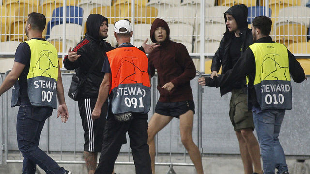 Stewards try to stop hooligans during clashes before the UEFA Champions League play off second leg football match Dynamo Kyiv vs Ajax in Kyiv, Ukraine, on August 28, 2018.