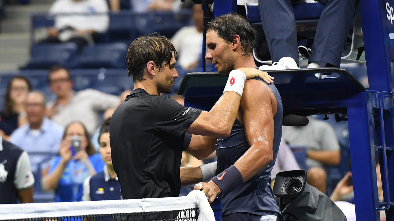 Rafael Nadal of Spain (R) and David Ferrer of Spain meet at the net after Ferrer retired during their 2018 US Open men's Singles match at the USTA Billie Jean King National Tennis Center in New York on August 27, 2018. - World number one and defending US Open champion Rafael Nadal sent his close friend David Ferrer into Grand Slam retirement on Monday when his veteran compatriot was forced to quit their first round match with an injury.