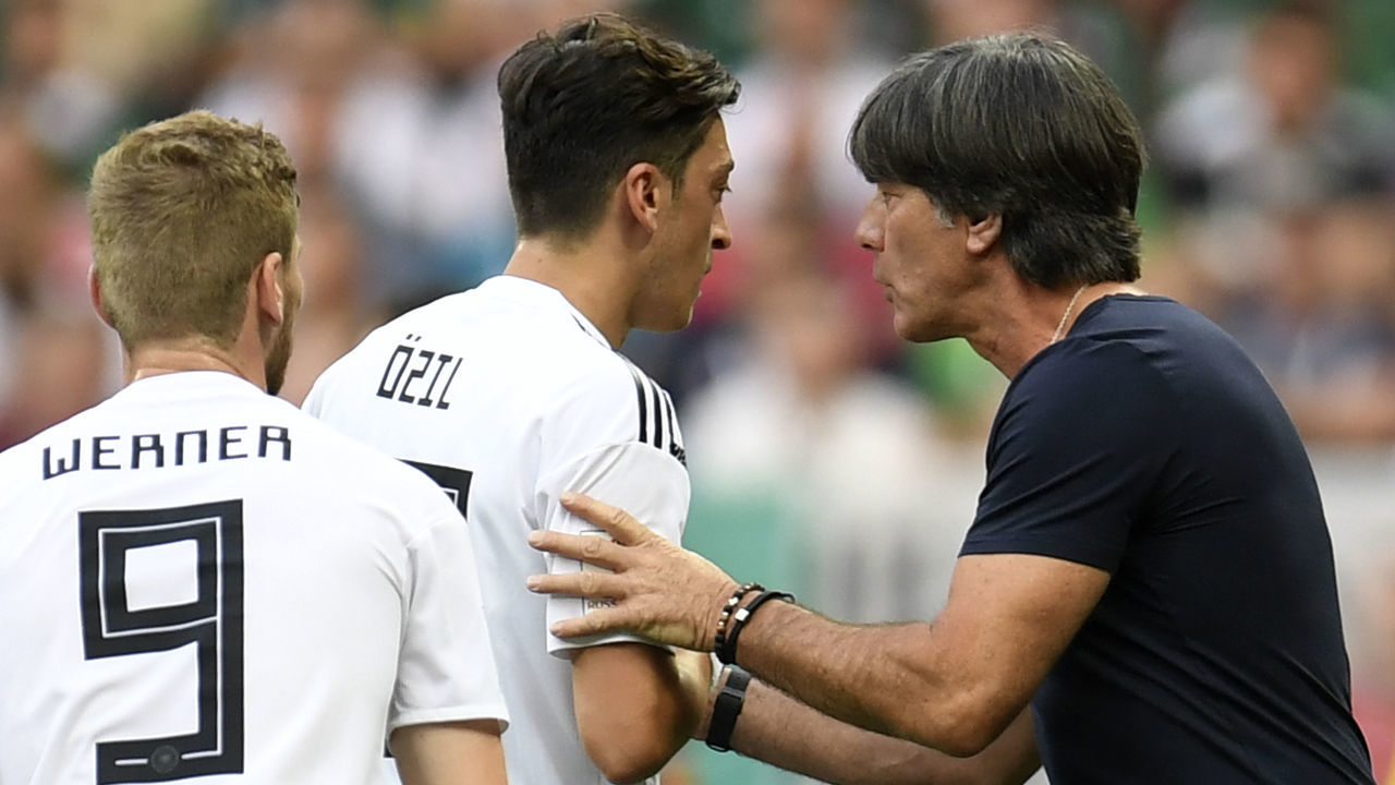 Germany's coach Joachim Loew (R) speaks with Germany's midfielder Mesut Ozil (L) during the Russia 2018 World Cup Group F football match between Germany and Mexico at the Luzhniki Stadium in Moscow on June 17, 2018.