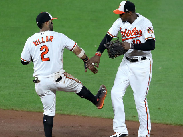 Manny Machado, Jonathan Schoop, and Adam Jones by Rob Carr