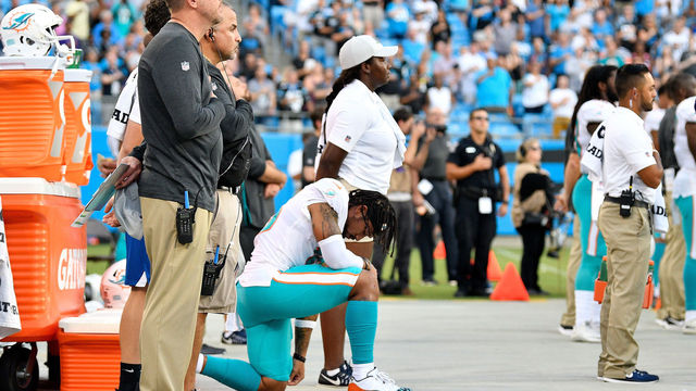 CHARLOTTE, NC - AUGUST 17: Albert Wilson #15 of the Miami Dolphins kneels during the anthem before their game against the Carolina Panthers at Bank of America Stadium on August 17, 2018 in Charlotte, North Carolina.