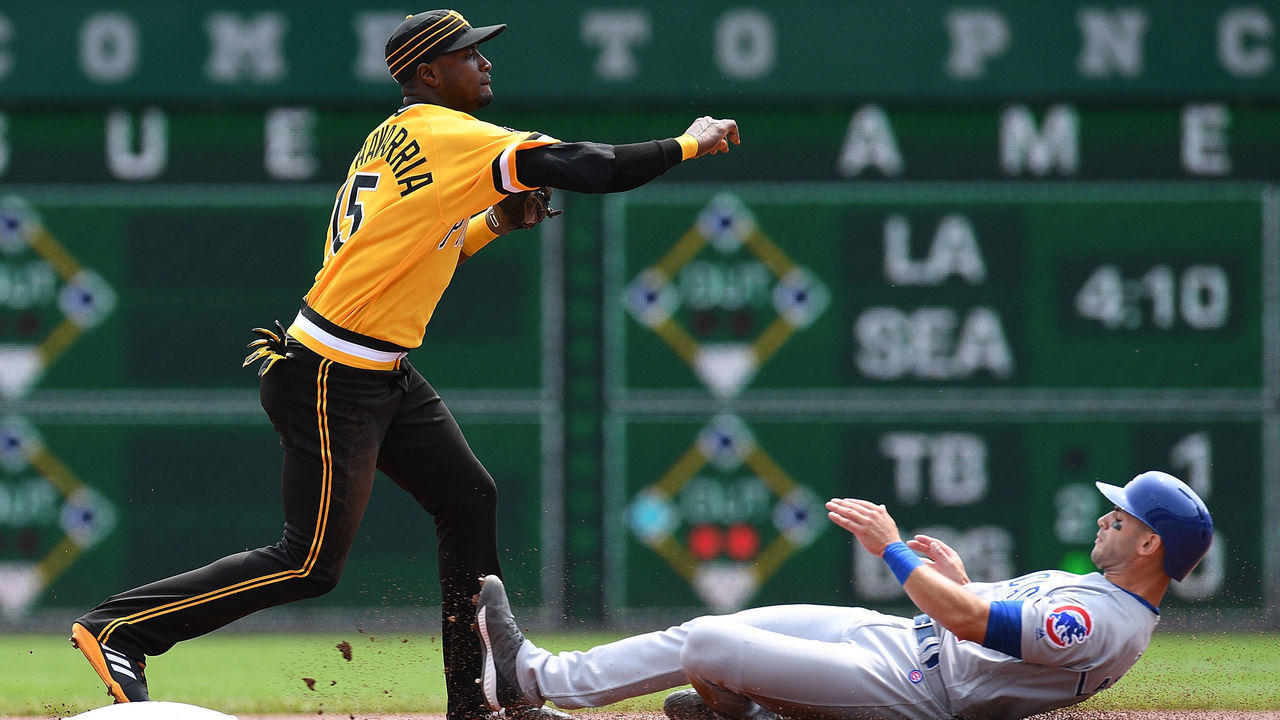 PITTSBURGH, PA - AUGUST 19: Adeiny Hechavarria #15 of the Pittsburgh Pirates turns a double play over Tommy La Stella #2 of the Chicago Cubs in the first inning during the game at PNC Park on August 19, 2018 in Pittsburgh, Pennsylvania.