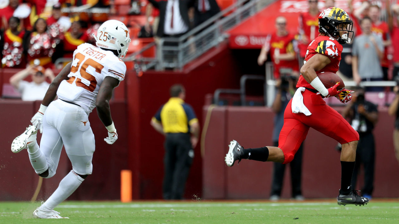 LANDOVER, MD - SEPTEMBER 1: Jeshaun Jones #6 of the Maryland Terrapins runs past B.J. Foster #25 of the Texas Longhorns for a first half touchdown after catching a pass at FedExField on September 1, 2018 in Landover, Maryland.